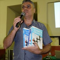 Prof. Marcelo Leão segura a enciclopédia de Luiz Both  